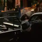 Fotograma coche Cadillac Fleetwood Serie 60 1955 negro de la película El Padrino