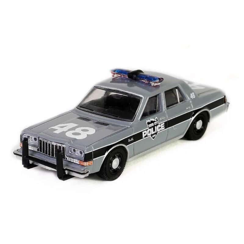 Miniatura coche policía Plymouth Gran Fury 1984 gris y negro de la película El Cuervo a escala 1/64 Greenlight